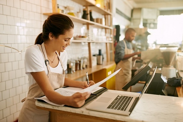 Young woman at laptop at cafe